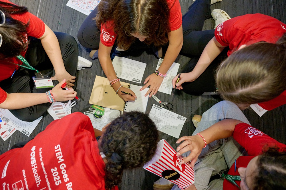 Overhead view of girls doing work on the floor.